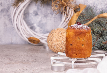 Italian sweet dessert panettone against festive background with sparklers.. rich Italian bread made with eggs, fruit, and butter and typically eaten at Christmas