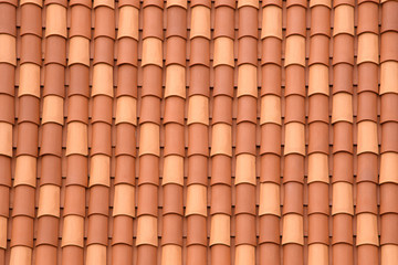 Fragment of a tiled roof. Clay tiles. Background. Pattern. Terracotta. Gray. Ocher.