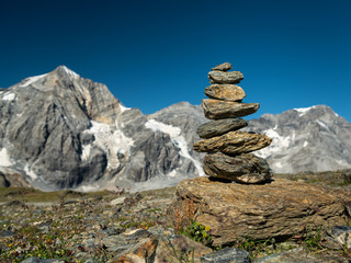 Stacked stones on Hintere Schoentaufspitze on a sunny day in summer