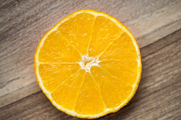 orange slice on a brown wooden background