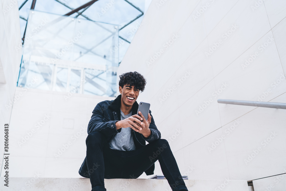 Poster latino hipster guy rejoicing at urban setting happy from received good comments and reviews for own 