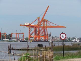 Fototapeta premium Translation: It is forbidden to camp. Container loading and unloading cranes.