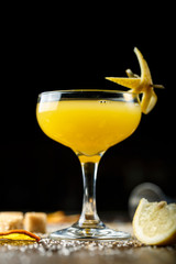 yellow cocktail in a glass