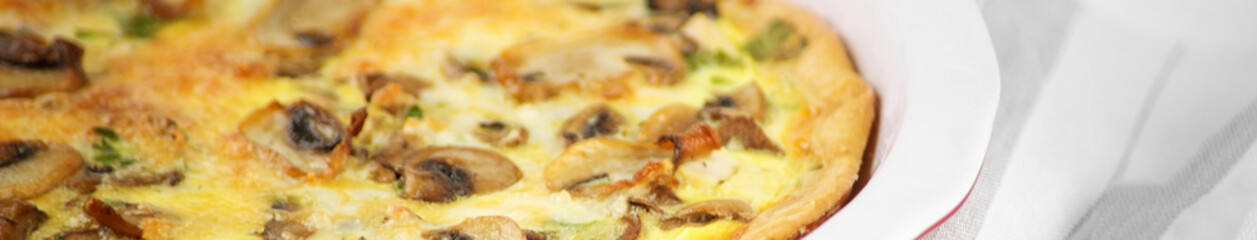 Quiche pie with chicken and mushrooms. Close-up. Banner for the site. The concept of food, breakfast.