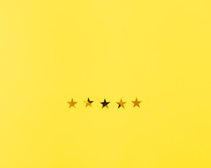 Five stars of golden color on yellow background