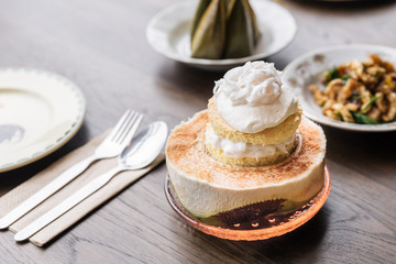 Coconut ice cream cake topping with coconut meat that serve in cut half coconut. Thai fusion dessert.