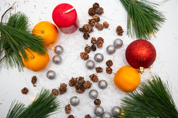 Fir branch and artificial snow along with Toys on white background. New Year and Christmas...