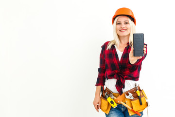 Portrait smiling young engineer woman wearing Yellow Safety helmet standing with mobile phone copy space isolated on white background studio