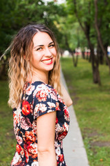 Happy woman laughing hotly on a city street. Close-up attractive caucasian woman with curly hair.