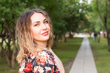 Happy woman laughing hotly on a city street. Close-up attractive caucasian woman with curly hair.