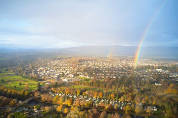 Banchory aerial view from above at river dee bridge during storm weather with rain, sun and rainbow