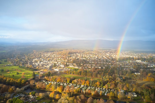Banchory aerial view from above at river dee bridge during storm weather with rain, sun and rainbow