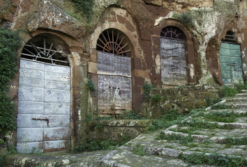 Fototapeta na wymiar Pitigliano, one of the best town in Tuscany, Italy. Cellar doors in the medieval district.