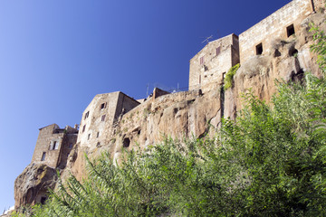 Pitigliano, one of the best town in Tuscany, Italy. Panoramic view from a path in a forest sorrounding the city.