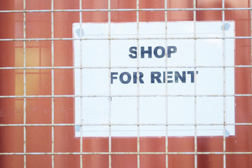 Shop for rent sign on building window
