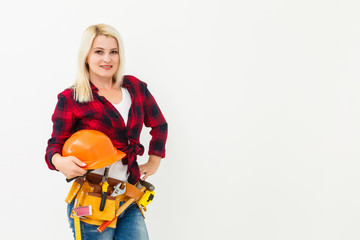 Naklejka premium working woman in helmet with tools