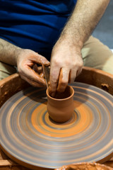 hands that shape the clay pottery Turning