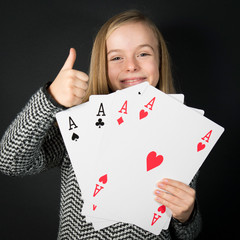 Little Girl 10Y Old Holding Giant Cards In the Hand: Poker of Aces. 