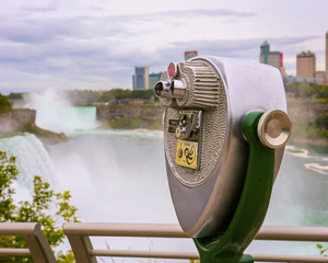 Niagara Falls in the background and binoculars as seen from the USA