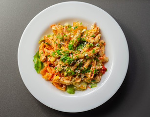 Piri piri style chicken on a bed of wholewheat pasta and vegetables, with a cool sour cream and chive dressing