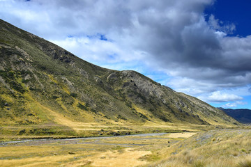 Beautiful landscape in New Zealand with yellow grassland and mountains. Molesworth station, South Island.