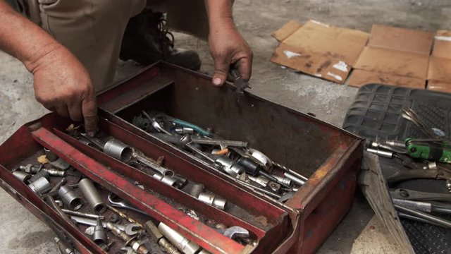 mechanic hand in the toolbox