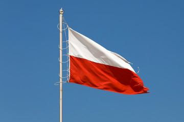 Flag of Poland is seen against the blue sky