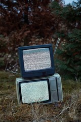 White noise and nothing on two analogue TV sets in outdoor environment