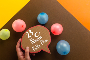 cocuk bayrami 23 nisan , Turkish April 23 translated to national sovereignty and Children's day, hand holding bubble chat