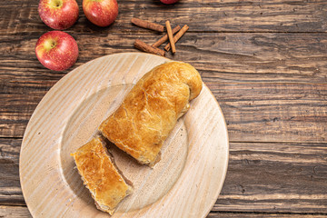 Traditional apple strudel on rustic wooden background