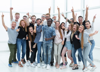 team of happy young people showing their success