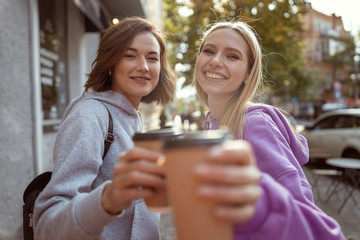 Close up of happy girls that enjoying tasty coffee
