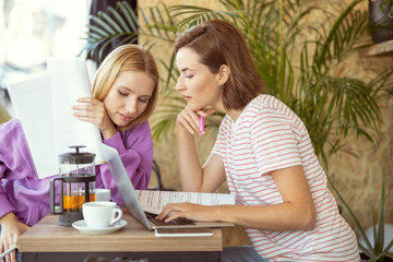 Attentive young female listening to her friend