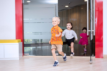 Fototapeta premium Cute schoolchildren running outside after studying