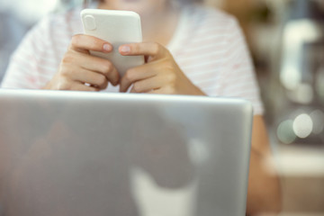 Focused photo on female hands that holding smartphone