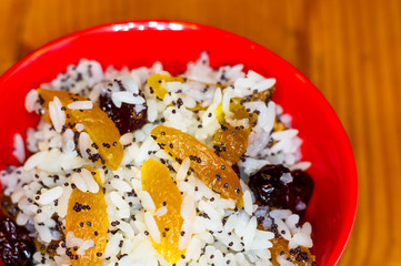 handmade preparation of treats for traditional Orthodox Christmas - rice pudding with fruits, cranberries, honey, nuts, Church candles
