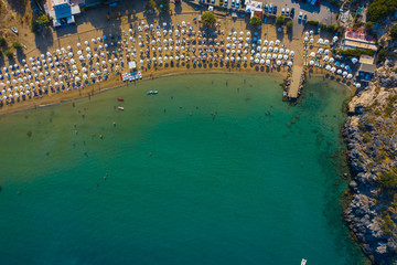 Fototapeta na wymiar bird's eye view of beach and the Bay of the Greek island of Rhodes, beautiful lagoon, swimming people, the concept of holiday resort
