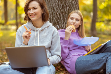 Positive delighted girl creating plans for project work