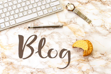 blog concept. workplace : keyboard and hand watch, pen and cookies