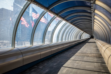 Pedestrian tunnel in downtown Detroit showing American flags outside