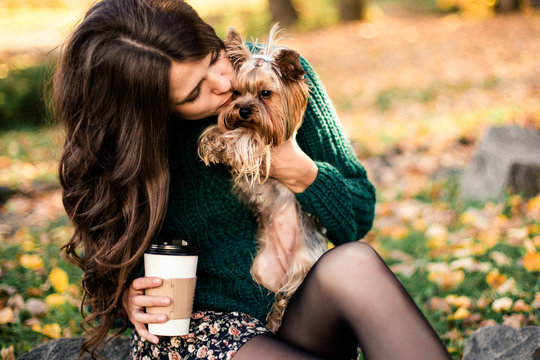 Beautiful Woman Walk With Dog And Drink Coffee In The Park.