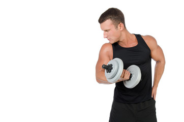 Fitness and healthy lifestyle. Young attractive guy at the gym.