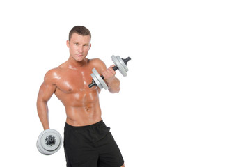 Fitness and healthy lifestyle. Young attractive guy at the gym.