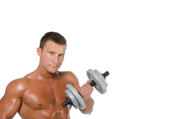 Fitness and healthy lifestyle. Young attractive guy at the gym.