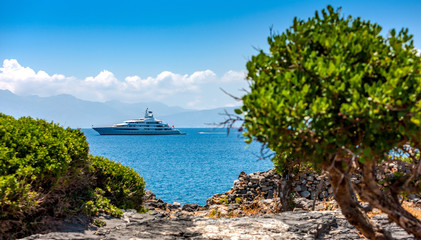 Large luxury white yacht off the coast of Crete, Greece.