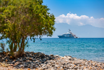 Large luxury white yacht off the coast of Crete, Greece.