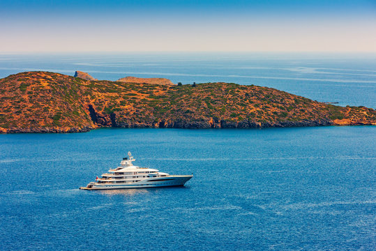Large luxury white yacht off the coast of Crete, Greece.