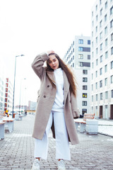 young pretty teenage girl posing cheerful happy smiling wearing street style outside in europe city, lifestyle people concept