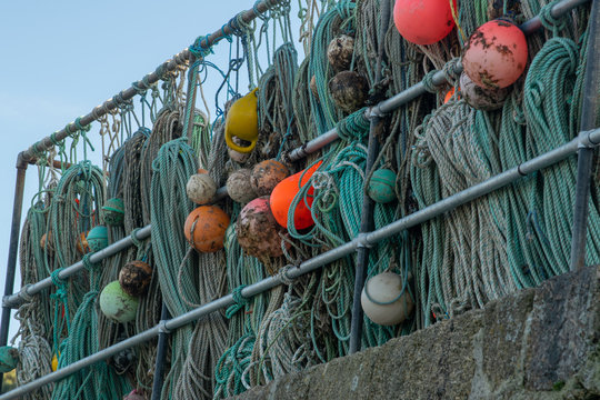 Fishing nets hanging on railings in a harbour