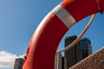 Sydney skyscrapers behind red lifebuoy. Sydney, Australia